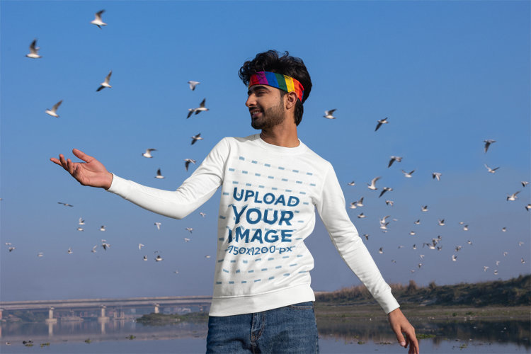 Sweatshirt Mockup of a Happy Man Posing by a Lake With an LGBT Sweatband