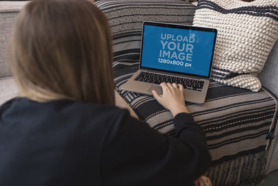 MacBook Mockup of a Woman Working on a Couch