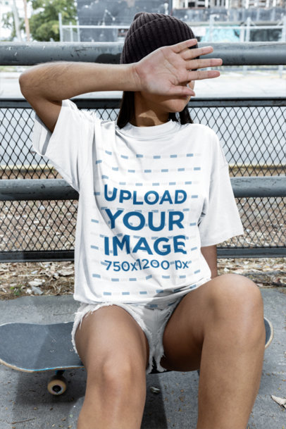 Oversized Tee Mockup Featuring a Woman Sitting on a Skateboard