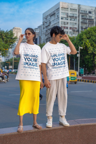 Blinkstore T-Shirt Mockup of a Man and a Woman With Serious Look Standing in the Street