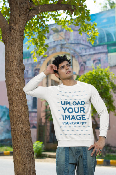 Sweatshirt Mockup Featuring a Man Leaning on a Tree With a Thoughtful Expression