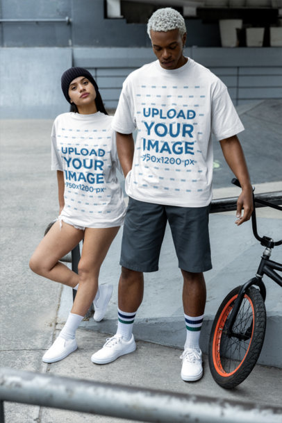 Oversized T-Shirt Mockup Featuring a Serious Woman and a Man Posing With a Street Style