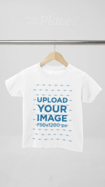 Video of a Gildan Round-Neck T-Shirt Placed on a Wooden Hanger Featuring a Gray Background