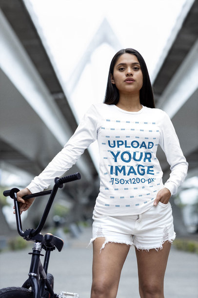 Bella Canvas Long Sleeve Tee Mockup of a Woman Standing Next to Her Bike