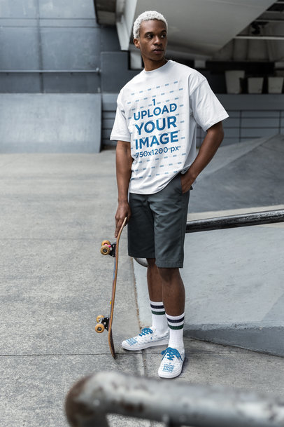 T-Shirt and Low Sneakers Mockup of a Man Posing with His Skateboard m38287