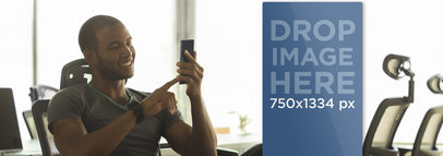 Young Entrepreneur at Conference Desk Using His Smartphone 