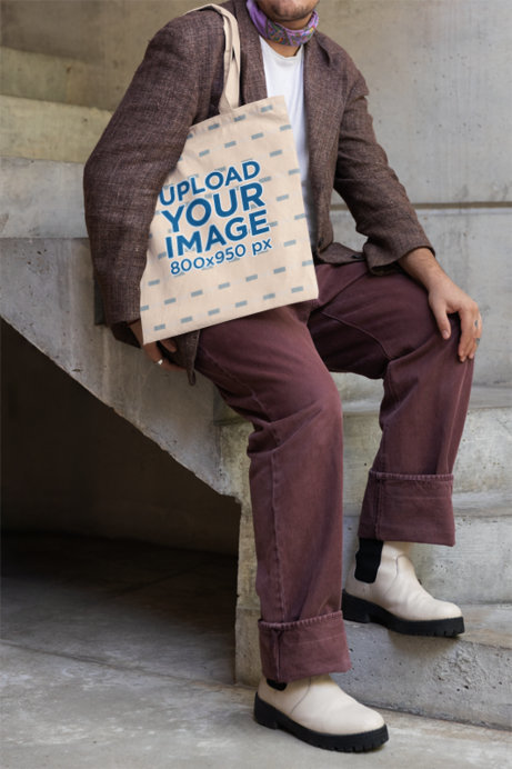 Mockup of a Cropped-Face Person Leaning on a Staircase and Carrying a Tote Bag
