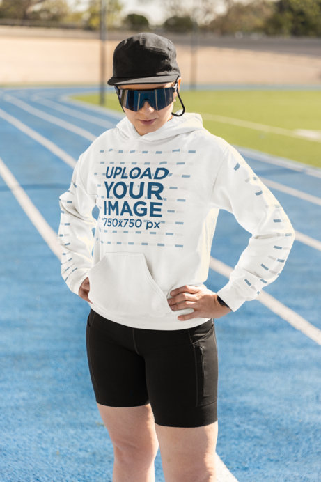Gildan Pullover Hoodie Mockup of a Fitness Woman in a Running Track