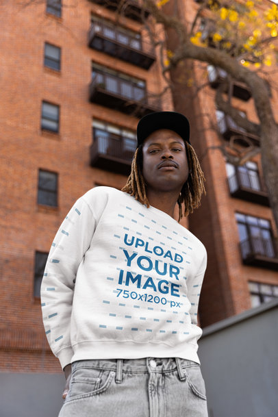 Hip Hop Mockup with a Man Wearing a Sweatshirt in Front of an Apartment Building