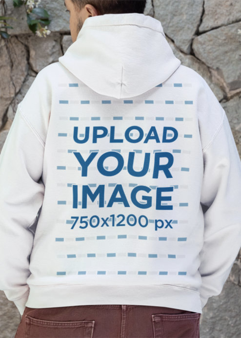 Back-View Hoodie Mockup Featuring a Person Standing in Front of a Rock Wall