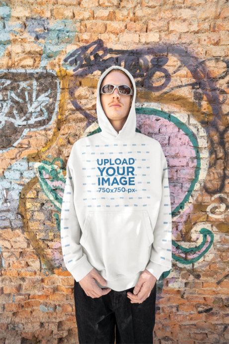 Oversized Hoodie Mockup Featuring a Man Posing Against a Graffiti Wall