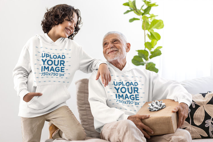 Gildan Hoodie Mockup Featuring a Senior Man With a Gift Smiling With a Boy for Father's Day