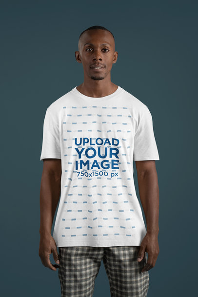 Mockup of a Smiling Man Standing in a Studio Wearing a Crewneck Bella Canvas Tee
