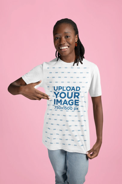 Bella Canvas Mockup of a Happy Woman Pointing at Her Round-Neck Tee in a Studio