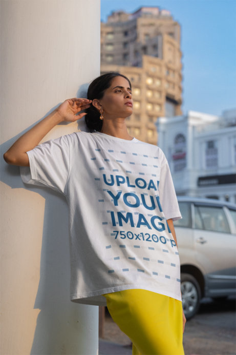 Oversized Blinkstore Tee Mockup of a Woman Leaning Against a Column