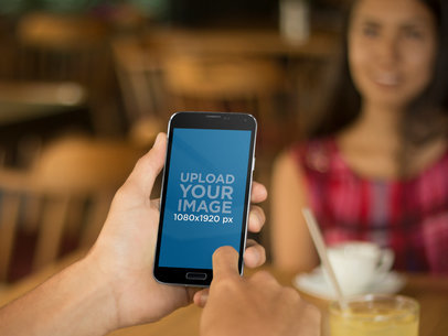 Young Couple Eating Breakfast at a Restaurant Featuring a Galaxy S5