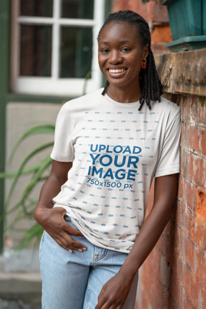 Bella Canvas T-Shirt Mockup Featuring a Smiling Woman Posing Against a Brick Wall