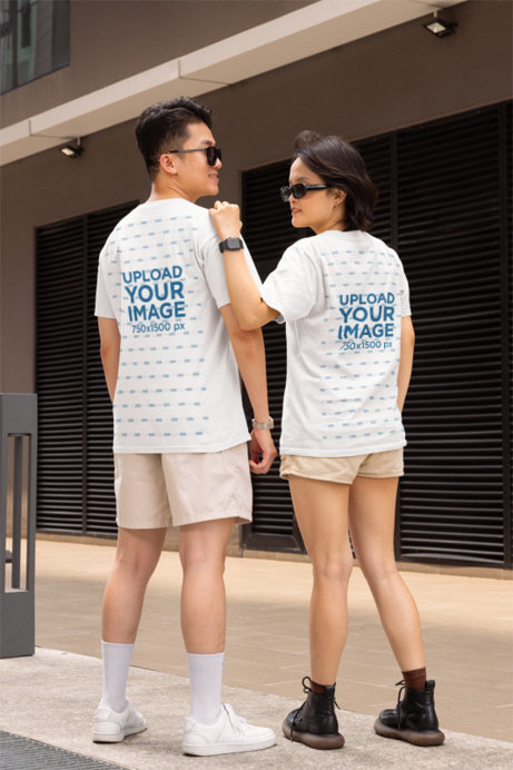 Back-View Gildan T-Shirt Mockup Featuring a Smiling Man and Woman in an Urban Street