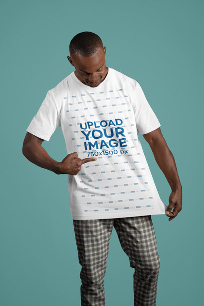 Mockup Featuring a Man Pointing at His Bella Canvas T-Shirt in a Studio