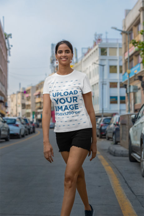 Mockup of a Smiling Woman Wearing a Crewneck T-Shirt from Gildan on the Street