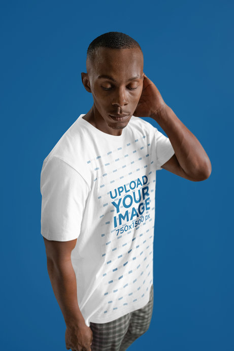Mockup Featuring a Man Posing with a Round-Neck Bella Canvas T-Shirt
