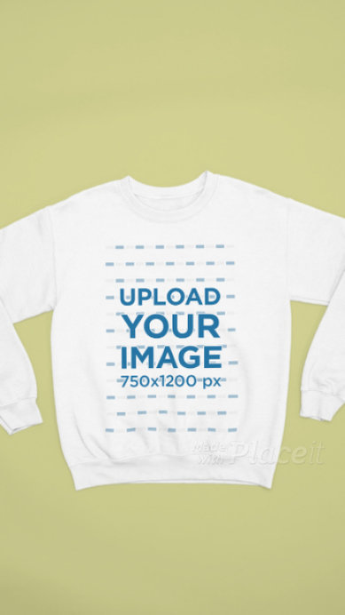 Video of a Crewneck Sweatshirt Lying on a Colorful Backdrop