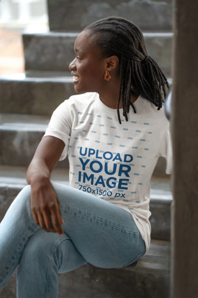 Bella Canvas Mockup Featuring a Smiling Woman Wearing a T-Shirt and Sitting on a Staircase