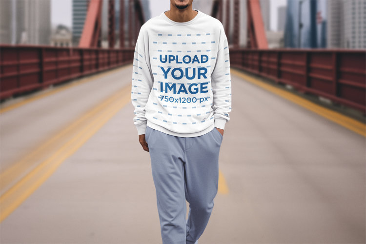 Sweatshirt Mockup Featuring an AI-Created Cropped-Face Man Walking in a City Bridge
