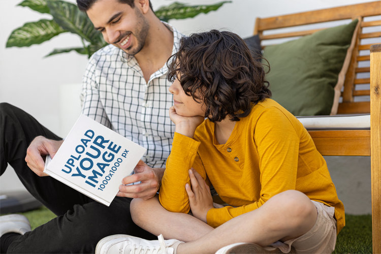 Mockup of a Man Reading a Book to His Son for Father's Day