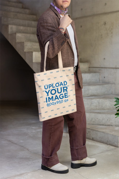 Mockup of a Person Carrying a Sublimated Tote Bag in Front of a Staircase