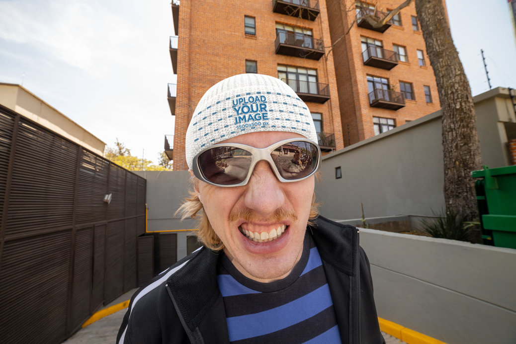 Mockup of a Funny Man Wearing a Fisherman Beanie and Posing Against a Building