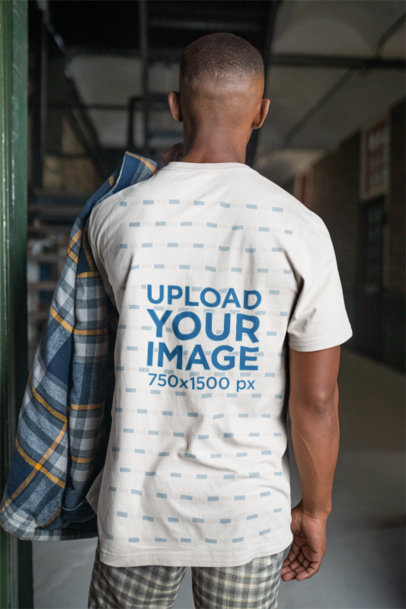 Back-View Bella Canvas Tee Mockup of a Man Standing in a Dark Room