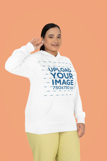 Mockup of a Woman Wearing a Plus Size Gildan Pullover Hoodie in a Studio