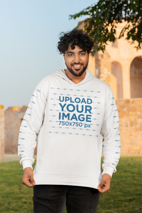 Gildan Hoodie Mockup Featuring a Cheerful Bearded Man Posing in a Park