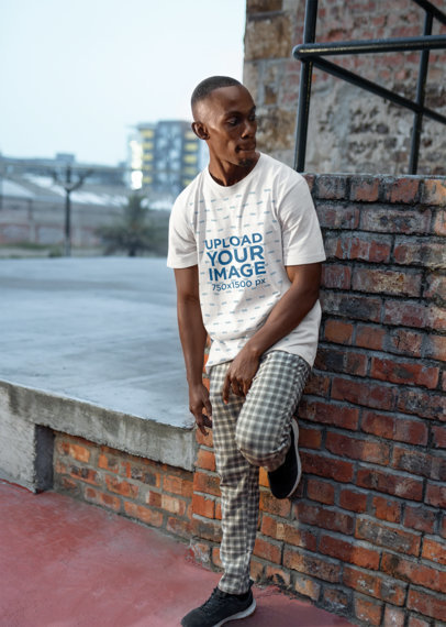 Bella Canvas Tee Mockup of a Man Leaning Against a Brick Wall