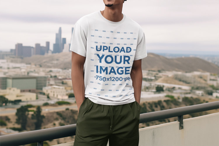 AI-Created Mockup of a Joyful Man Wearing a Round-Neck T-Shirt on a Balcony