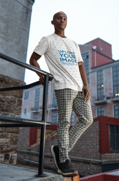 Bella Canvas T-Shirt Mockup of a Man Posing on the Top of a Roof