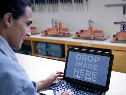 Mockup of Engineer at Industrial Workshop Using an HP Laptop