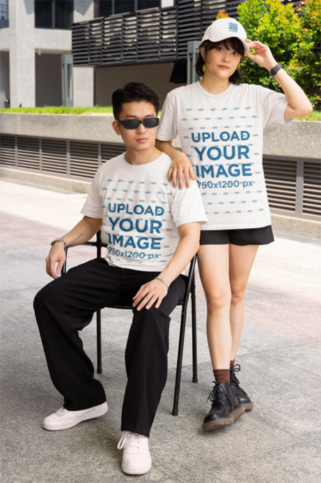 Dad Hat and Gildan T-Shirt Mockup Featuring a Man in a Chair Posing With a Woman