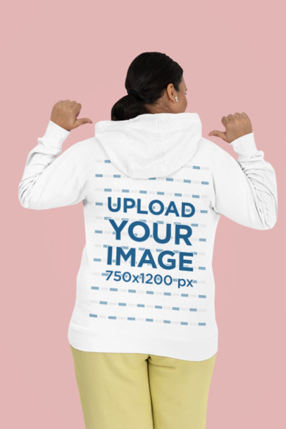 Back-View Mockup Featuring a Woman Happily Pointing at Her Gildan Hoodie m39567