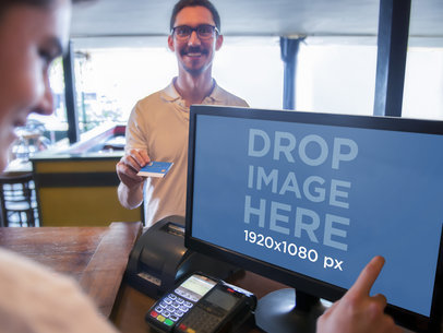 Mockup of a Young Cashier Using PC Desktop for Sales Transaction