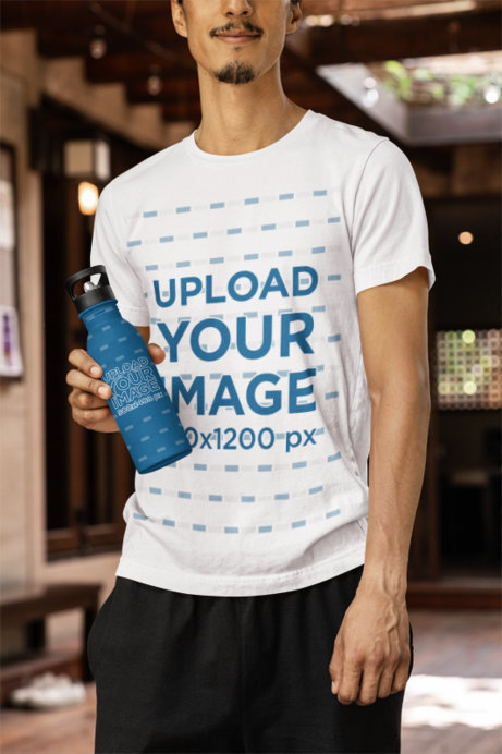 Bella Canvas Tee Mockup of a Cropped-Face Man With an Aluminum Bottle Posing in a Yoga Studio