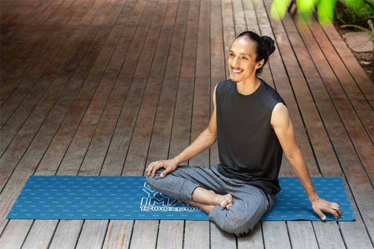 Mockup of a Happy Man Sitting on a Yoga Mat