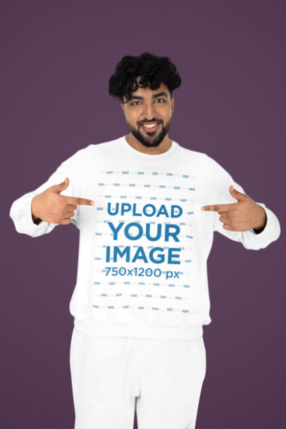 Mockup of a Happy Bearded Man Pointing at His Crewneck Sweatshirt in a Studio