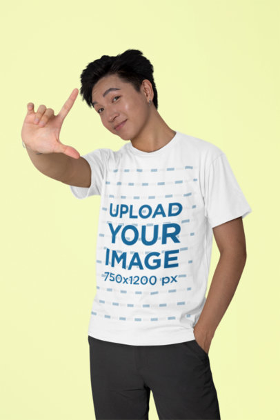 Bella Canvas T-Shirt Mockup Featuring a Smiling Man Doing a Hand Camera Gesture m40238