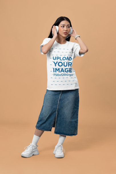 Bella Canvas T-Shirt Mockup Featuring a Woman With Headphones Posing in a Studio