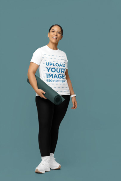 Bella Canvas T-Shirt Mockup Featuring a Smiling Woman Carrying Yoga Gear in a Studio