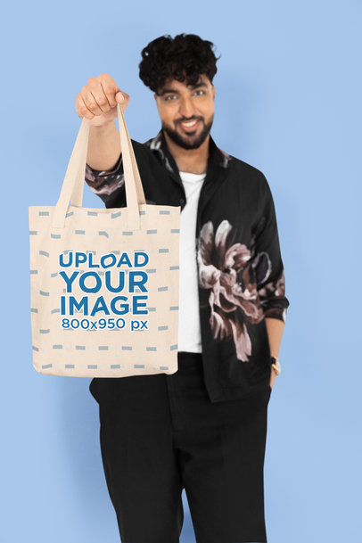 Mockup of a Smiling Man Showing His Tote Bag to the Camera
