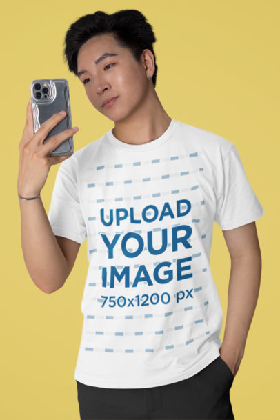 Mockup of a Man Taking a Selfie Wearing a Bella Canvas T-Shirt 