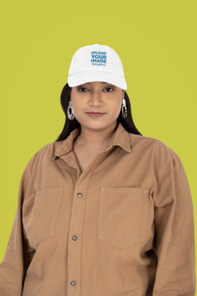 Mockup of a Woman with Big Earrings Wearing an Embroidered Dad Hat